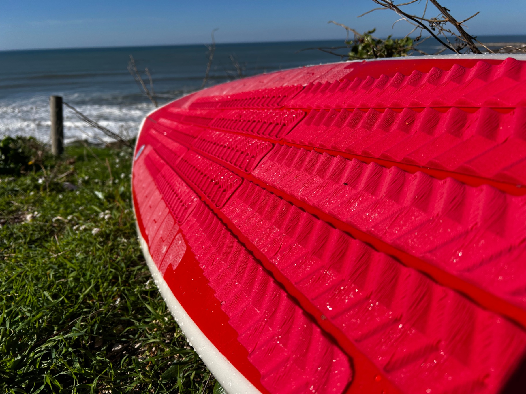 Red traction pad close-up showing 3D printed texture